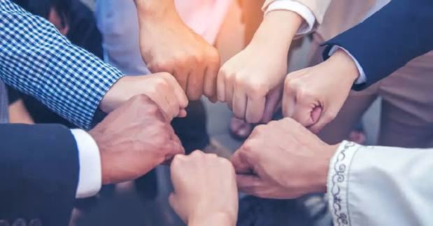 Team members joining fists together